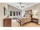 Main bedroom featuring large windows with beautiful views, ceiling fan, and neutral decor at 295 Cedar Rock Trl, Fuquay Varina, NC 27526