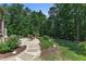 Picturesque outdoor patio featuring stone accents and landscaping, creating a serene setting for outdoor gatherings at 295 Cedar Rock Trl, Fuquay Varina, NC 27526