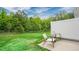 Inviting backyard with a well-maintained lawn, privacy fence, and patio seating area at 296 Perseus St, Angier, NC 27501