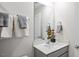Cozy bathroom featuring a gray vanity, white countertop, and a large mirror at 296 Perseus St, Angier, NC 27501