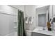 Bathroom with a shower-tub combo, grey vanity with quartz countertop, and decorative towels at 296 Perseus St, Angier, NC 27501