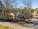 Aerial view of the home showcasing its setting within a tree-filled landscape and surrounding streets at 298 E Salisbury St, Pittsboro, NC 27312