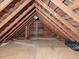 Exposed attic rafters create a spacious storage area, with a partially-covered floor at 298 E Salisbury St, Pittsboro, NC 27312