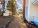 Manicured backyard features a gravel path, lush greenery, and a well, perfect for relaxing at 298 E Salisbury St, Pittsboro, NC 27312