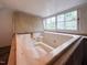 Bathtub with a large window for natural light at 298 E Salisbury St, Pittsboro, NC 27312