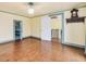 Spacious bedroom with hardwood floors, neutral walls, and doorway to the upper floor at 298 E Salisbury St, Pittsboro, NC 27312