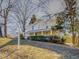 View of the yellow house and lawn with Thomas Hackney House sign at 298 E Salisbury St, Pittsboro, NC 27312
