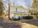 Charming yellow two-story home with a welcoming front porch and mature trees at 298 E Salisbury St, Pittsboro, NC 27312