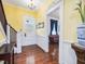 Entryway boasts gleaming hardwood floors and staircase with classic decor at 298 E Salisbury St, Pittsboro, NC 27312