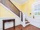 Traditional foyer features hardwood floors, a wooden staircase, and a classic white front door at 298 E Salisbury St, Pittsboro, NC 27312