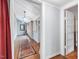 Hallway featuring wood-look floors, light blue walls, and classic trim creating a seamless transition between rooms at 298 E Salisbury St, Pittsboro, NC 27312