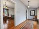 Hallway with hardwood floors leading to sunroom at 298 E Salisbury St, Pittsboro, NC 27312