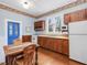 Charming kitchen featuring wood cabinets, hardwood floors, and stainless steel sink creating a cozy cooking space at 298 E Salisbury St, Pittsboro, NC 27312