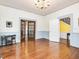 Spacious living room with gleaming hardwood floors and view to staircase at 298 E Salisbury St, Pittsboro, NC 27312