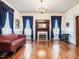 Elegant living room with hardwood floors, fireplace, and beautiful blue curtains at 298 E Salisbury St, Pittsboro, NC 27312