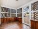 Enclosed porch features wood floors, lattice panels, and a serene outdoor view at 298 E Salisbury St, Pittsboro, NC 27312