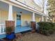 Inviting front porch with blue floor, rocking chair, and brick supports at 298 E Salisbury St, Pittsboro, NC 27312