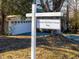 Historical 'Thomas Hackney House 1899' sign with a view of the detached garage in the background at 298 E Salisbury St, Pittsboro, NC 27312