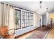 Bright sunroom with natural light, vintage rug, and a chair to create a cozy and inviting space at 298 E Salisbury St, Pittsboro, NC 27312
