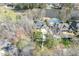 Aerial view of a stately home with landscaped grounds, pool, tennis court, and lake access at 302 Edinburgh Dr, Cary, NC 27511