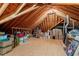 Spacious unfinished attic featuring exposed wooden beams and ample storage space at 302 Edinburgh Dr, Cary, NC 27511