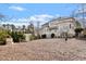 Expansive backyard featuring a white pergola and lush landscaping at 302 Edinburgh Dr, Cary, NC 27511