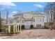 Expansive backyard featuring a white pergola, landscaping, and staircase at 302 Edinburgh Dr, Cary, NC 27511