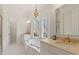 Elegant bathroom featuring a luxurious soaking tub, marble floors, and a stylish chandelier at 302 Edinburgh Dr, Cary, NC 27511