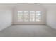 Bright, carpeted room with natural light from the large windows at 302 Edinburgh Dr, Cary, NC 27511