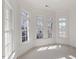 Sunlit room with ample windows and plush carpeting at 302 Edinburgh Dr, Cary, NC 27511