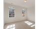 Sun-filled bedroom with plush carpeting and large windows showcasing natural light at 302 Edinburgh Dr, Cary, NC 27511