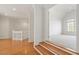 Upstairs hallway displaying the hardwood flooring leading to a cozy carpeted bedroom at 302 Edinburgh Dr, Cary, NC 27511