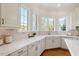 Bright kitchen with white countertops, modern appliances, and large windows at 302 Edinburgh Dr, Cary, NC 27511