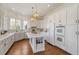 Modern kitchen features white cabinets, stainless steel appliances, and a large island at 302 Edinburgh Dr, Cary, NC 27511