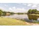 Picturesque lake view surrounded by lush trees and well-maintained green spaces at 302 Edinburgh Dr, Cary, NC 27511
