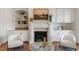 Inviting living room featuring built-in shelving, a fireplace, and comfortable seating in neutral tones at 302 Edinburgh Dr, Cary, NC 27511