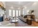 Cozy living room featuring a fireplace, tray ceiling, hardwood floors and stylish decor at 302 Edinburgh Dr, Cary, NC 27511