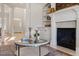 Bright living room with decorative fireplace, tall pillars, and refined accents at 302 Edinburgh Dr, Cary, NC 27511