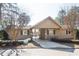 Exterior view of pool house with gated entry, landscaping, and a sign at 302 Edinburgh Dr, Cary, NC 27511