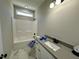 Bathroom featuring white cabinet with sink, tub with shower and a horizontal window at 314 S Darden St, Kenly, NC 27542