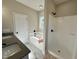 Well-lit bathroom featuring a walk-in shower, tub, and modern fixtures at 314 S Darden St, Kenly, NC 27542