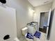 Bathroom features a white vanity, toilet, shower and stylish blue bathmat at 314 S Darden St, Kenly, NC 27542