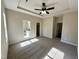 Bedroom with trey ceiling, ceiling fan, and connecting doors to bathroom and closet space at 314 S Darden St, Kenly, NC 27542