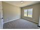 Bedroom features neutral carpeting and a window providing natural light at 314 S Darden St, Kenly, NC 27542