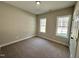 Cozy bedroom with neutral carpeting, two bright windows, and a ceiling light at 314 S Darden St, Kenly, NC 27542