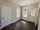 Simple dining room featuring hardwood-style floors, a chandelier, and neutral colored walls at 314 S Darden St, Kenly, NC 27542