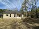Exterior view of home with yard, trees, and a covered back porch at 314 S Darden St, Kenly, NC 27542