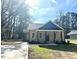 Charming one-story home featuring a covered porch, gray siding, and blue shingle accents at 314 S Darden St, Kenly, NC 27542