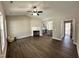 Open concept living area featuring a fireplace, ceiling fan, and hardwood-style flooring at 314 S Darden St, Kenly, NC 27542