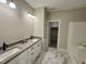 Bathroom featuring double sinks with modern fixtures and a walk in closet at 315 S Maple Ave, Kenly, NC 27542